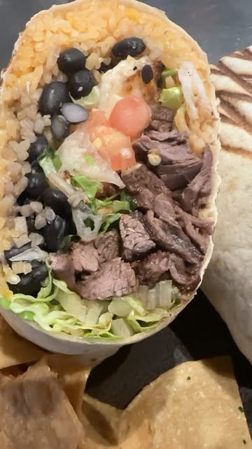 Close-up of a loaded steak burrito from Instagram